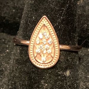 Pear shaped rose gold tone ring with clear gems